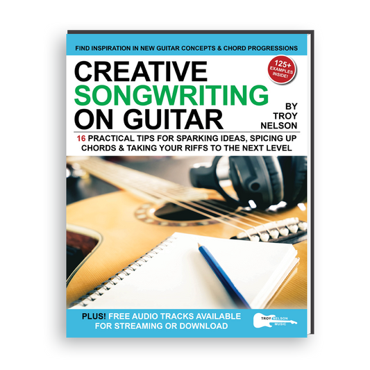 Image of a Guitar and notepad on a Book Cover